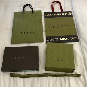 Two Gucci boxes with two Gucci bags along with a matching  Gucci ribbon